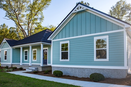 House with blue-green vinyl siding