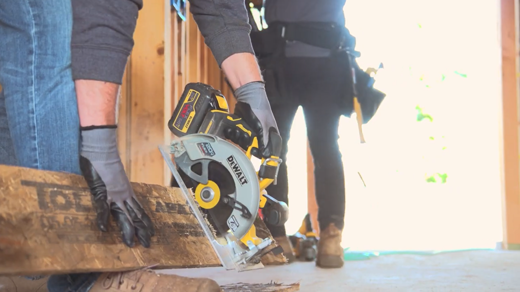 Person cutting through wood with saw