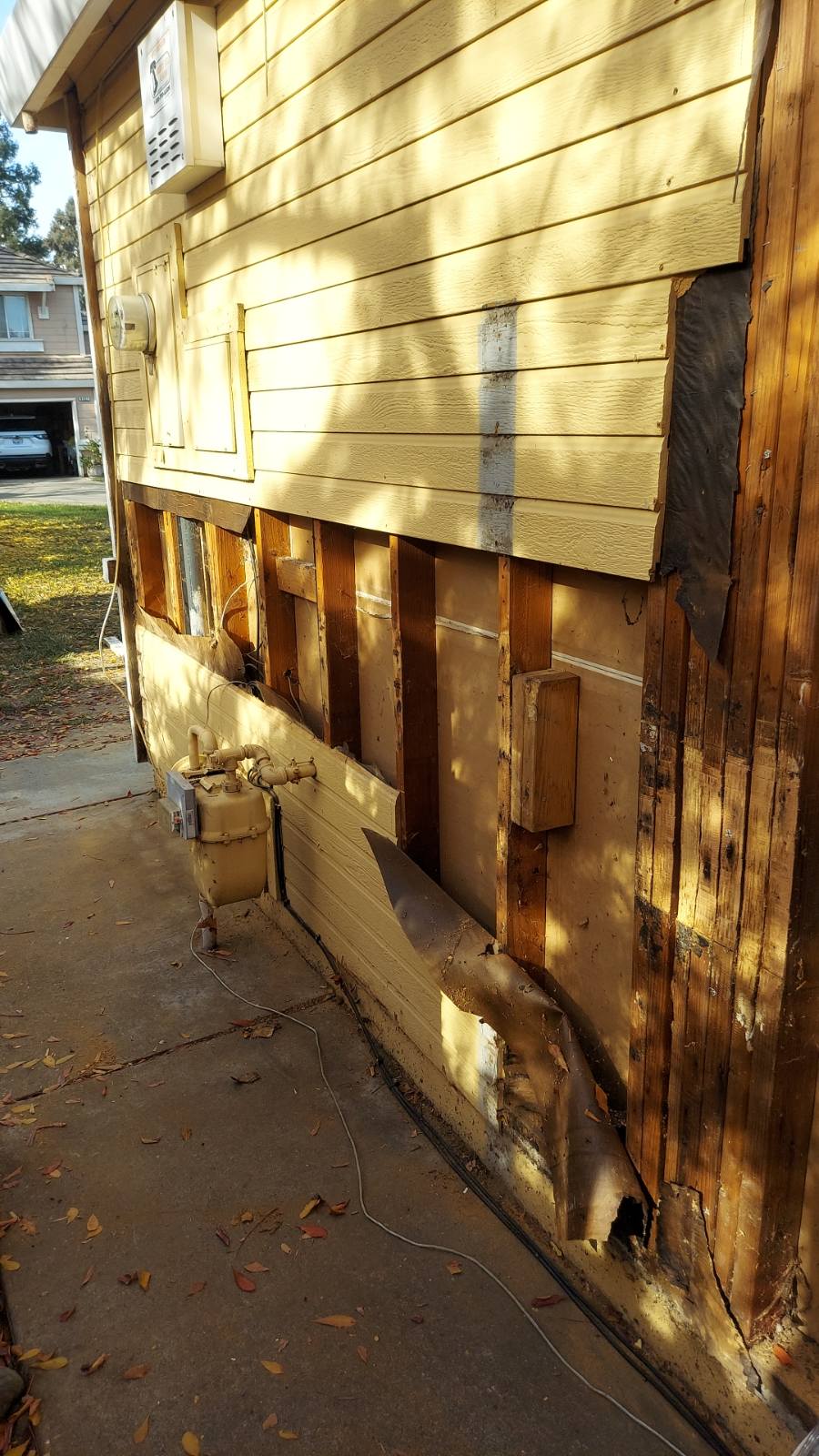 Damaged siding, damaged sheer wall, and other wood rot materials removed Photo