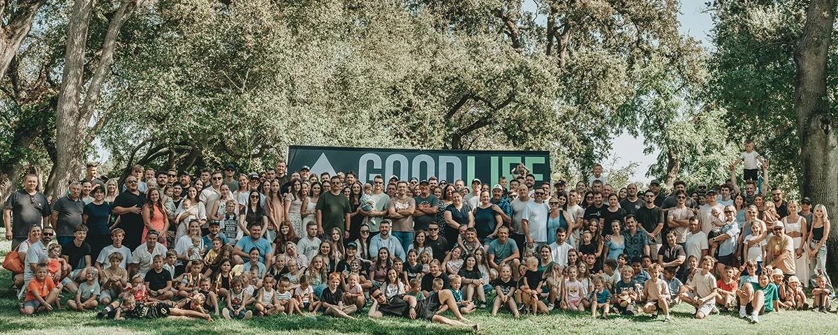 Good Life Construction team members with their families gathered outdoors at the GLC company picnic