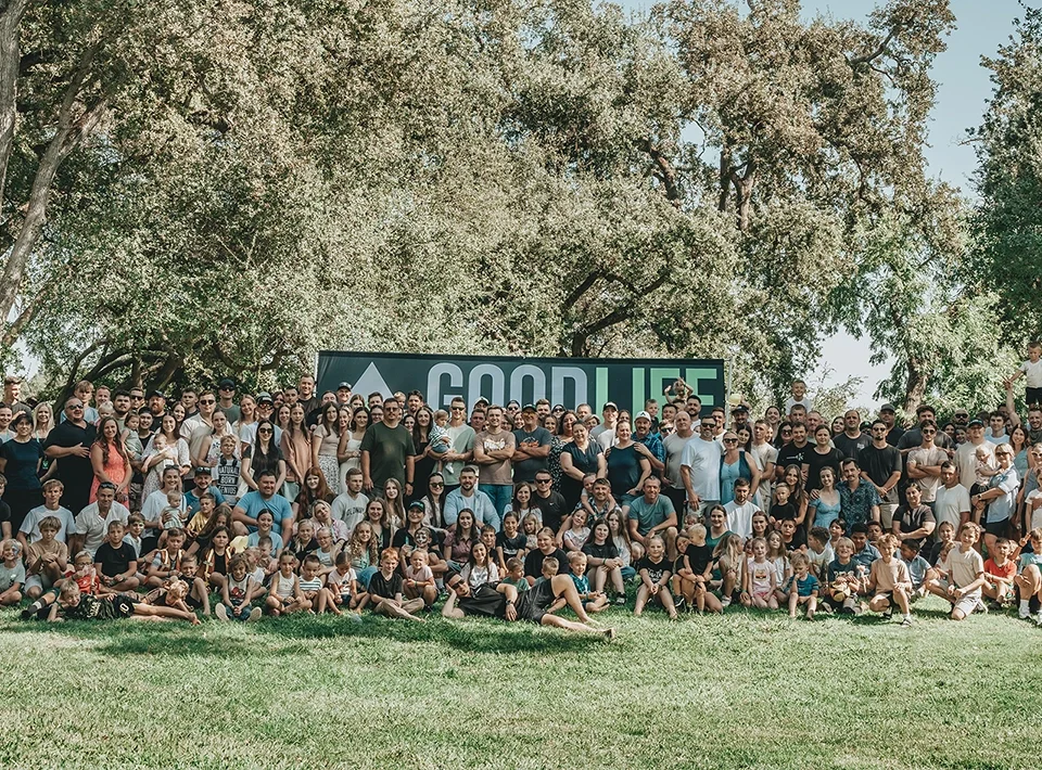 Good Life Construction team members with their families gathered outdoors at the GLC company picnic