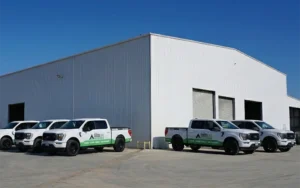 Good Life Construction trucks parked near commercial building for capital improvement services