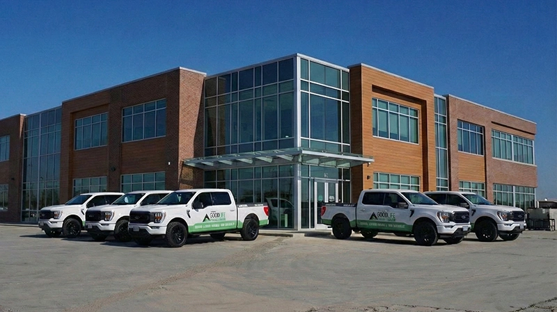 Good Life Construction company trucks outside commercial workspace